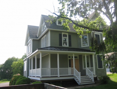 Metal roof covered porch, vinyl siding and exterior trim work